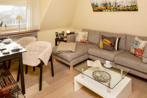 a living room with a couch and a table at Luv in List