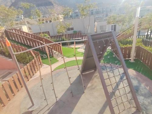 a swing set in a park with a playground at IL MONTE Galala -families only- المونت جلالة in Ain Sokhna
