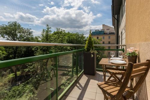 a balcony with a table and chairs on a balcony at Fragola Apartments Old Town in Kraków