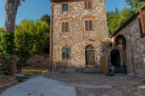 a large stone building with a door on it at Vacation Home Tuscany Pisa-Lucca 1 in Filettole
