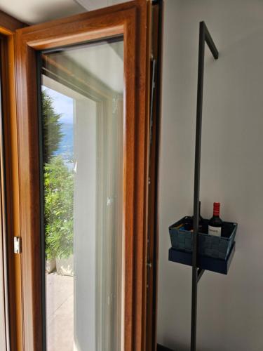 a glass door with a window with two bottles of wine at B&B I LAKE IT BELLAGIO in Bellagio