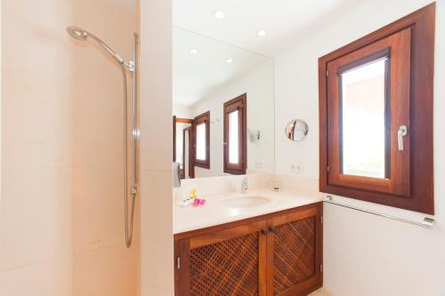 a bathroom with a sink and a shower at Stunning Modern Ibiza Villa with Private Pool,1252 in Cala Vadella