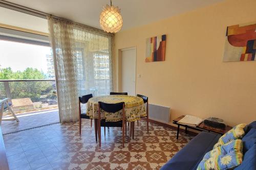 un salon avec une table et un canapé dans l'établissement Bright seafront apartment, à Fréjus
