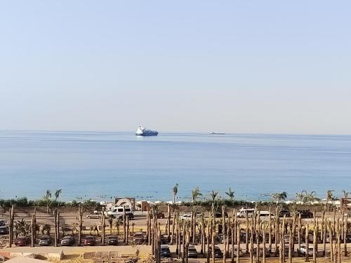 a beach with a boat in the water at IL MONTE Galala -families only- المونت جلالة in Ain Sokhna