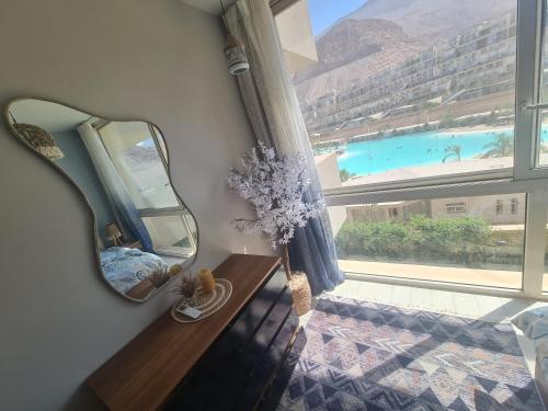 a mirror sitting on a shelf next to a window at IL MONTE Galala -families only- المونت جلالة in Ain Sokhna