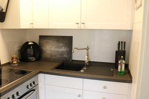 a kitchen with a sink and a counter top at Ferienwohnung zum Schwandter See in Schwandt