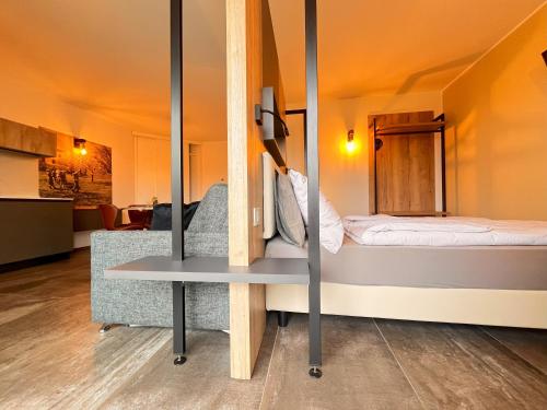 a small room with a bed and a table at Maso Valèr - Agritur in Tassullo