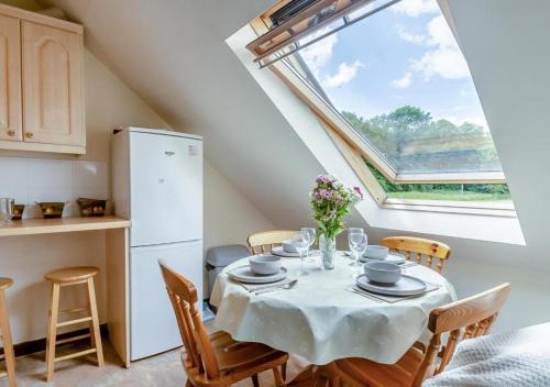 a kitchen and dining room with a table and chairs at The Ducks - Gorgeous Norfolk Upside down Cottage - with Lazy Spa in Mileham