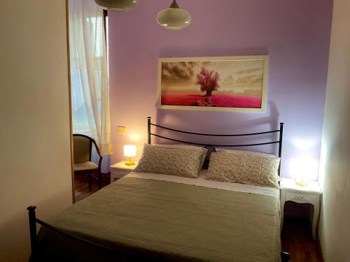 a bedroom with a bed with two lights on at Al Duomo in Ronciglione