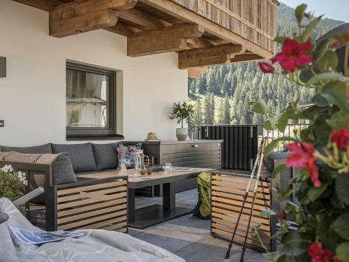 a patio with a couch and a table at Ferienhaus Evelyn in Tux