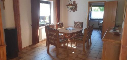 a dining room with a wooden table and chairs at Ferienhaus Korn mitten im schönen Pfälzer Wald, Privat Haus in Bruchweiler-Bärenbach