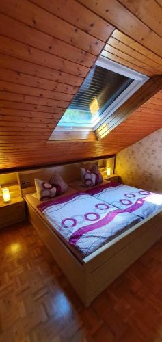 a bedroom with a large bed in a wooden ceiling at Ferienhaus Korn mitten im schönen Pfälzer Wald, Privat Haus in Bruchweiler-Bärenbach