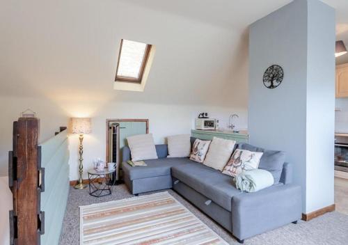 a living room with a couch and a table at The Ducks - Gorgeous Norfolk Upside down Cottage - with Lazy Spa in Mileham