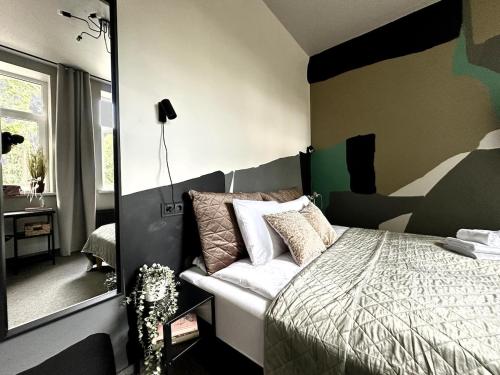 a bedroom with a bed and a mirror at RixStay Apartments in Rīga