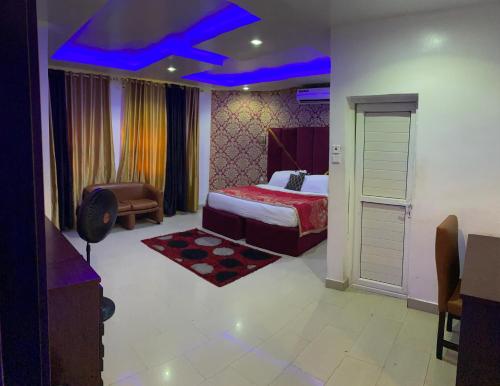 a bedroom with a bed and a blue ceiling at Royal Winners Hotel, Port Harcourt, Nigeria in Port Harcourt