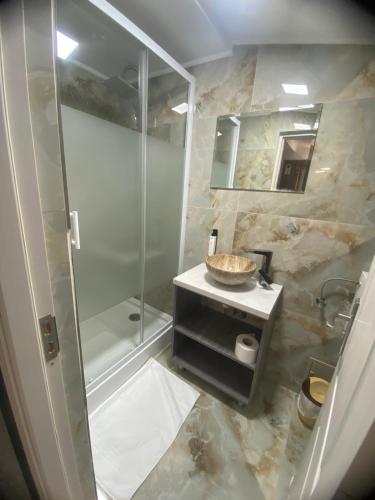 a bathroom with a shower and a sink at Flamingo Hotel in Piteşti
