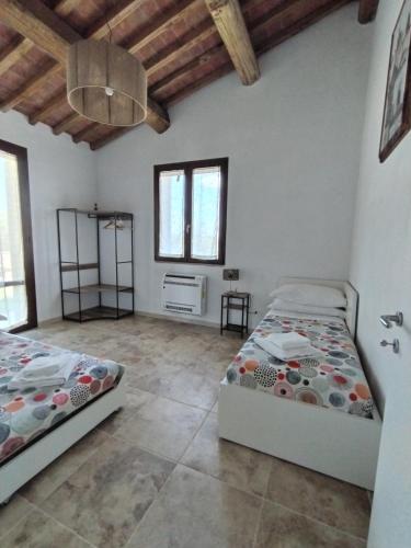 a bedroom with two beds in a room at Agriturismo Poggio Rotondo in San Gimignano