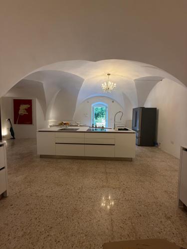 a kitchen with an arched ceiling with a counter and a sink at Suite Royale Palazzo Villani Lubelli in Cannole