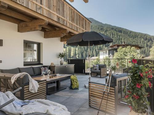 a patio with a table and an umbrella at Ferienhaus Evelyn in Tux