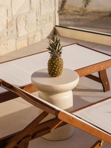 a pineapple sitting on top of a coffee table at Alýria Sea Side Suites in Agios Nikolaos