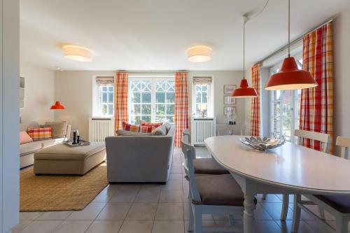 a kitchen and living room with a table and chairs at Haus Marie in Utersum