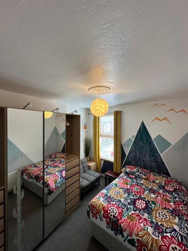 a bedroom with two beds and a couch at Cheerful 4 bedroom townhouse, side street parking in Belfast
