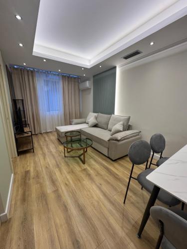 a living room with a couch and a table at Luxury Apartments Lezha in Lezhë