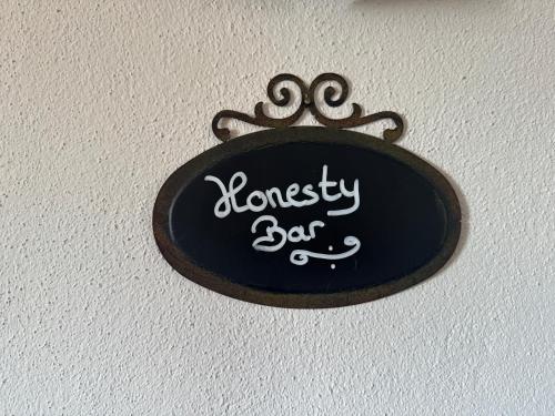 a black sign with the name of a fancy bar at Hotel Montfort-Schlössle in Lindau