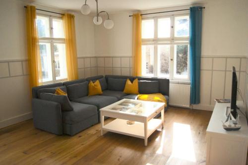 a living room with a couch and a coffee table at Ferienwohnung "Der Segler" in Barth
