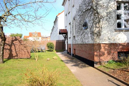 an empty sidewalk next to a brick building at Ferienwohnung "Der Segler" in Barth