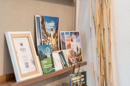 a shelf with books and pictures on it at Ferienwohnung Eckis Eck in Rickenbach