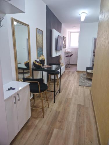 a living room with a table and chairs at Relax In in Belgrade