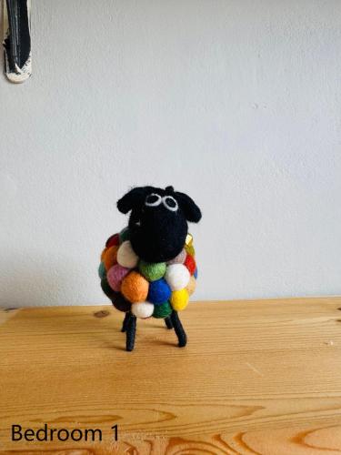 a toy sheep with glasses on a table at Tranquil 2 Bedroom Rose Cottage near Stratford in London