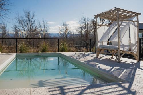 a swimming pool with a slide and a chair and a swing at Paso Calmo Cabañas in Villa General Belgrano