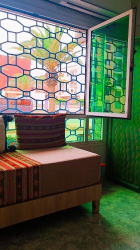 a bedroom with a stained glass window and a bed at Riad SULTANA lateral seaview in Saidia 