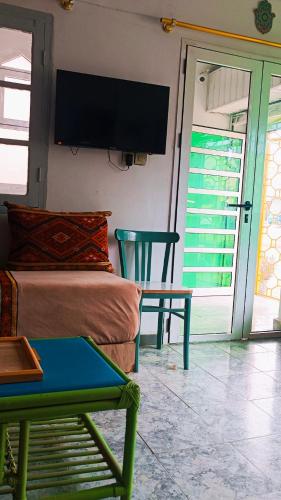 a room with a couch and a table and a tv at Riad SULTANA lateral seaview in Saidia 