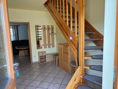 a staircase leading to a living room with a table at Wiedemann Heiko in Mellenthin