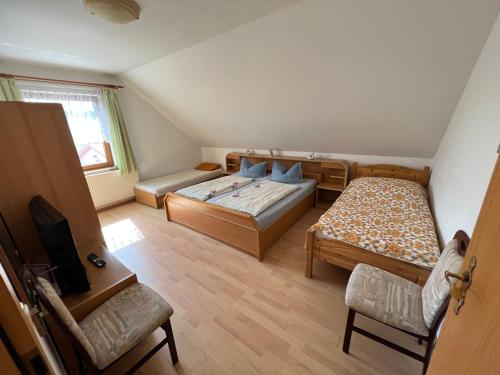 a small room with two beds and a television at Wiedemann Heiko in Mellenthin