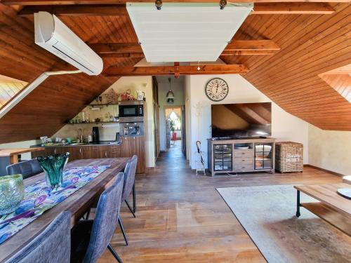 a kitchen and dining room with a long table at Apartmány Black Stork Golf in Veľká Lomnica