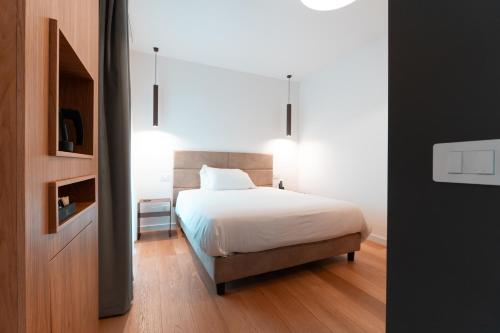 a bedroom with a bed with a white bedspread at Il Bersagliere Guest House in Colonna