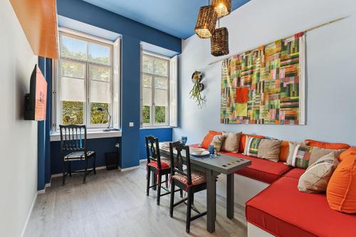 a living room with a red couch and a table at GuestReady - AMMA Braga Apartments in Braga