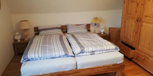 a bedroom with a bed with two pillows at Ferienwohnung Paula in Buxtehude