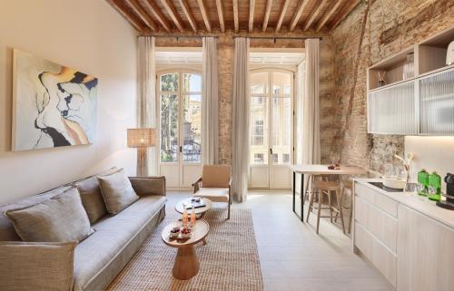 a living room with a couch and a table at Coeo Santa Maria Cathedral Signature Apartments in Málaga