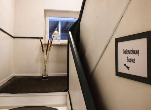 a stairway with a vase of flowers in a room at Ferienwohnung Seerose in Hemfurth-Edersee