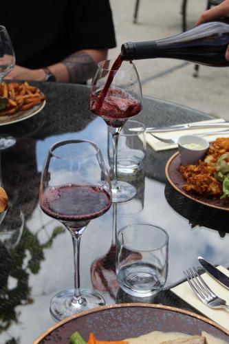 two glasses of wine are sitting on a table at Hôtel Restaurants & Spa Perier Du Bignon in Laval