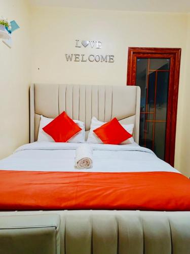 a large bed with red pillows in a room at Rosette Haven 2 in Nairobi
