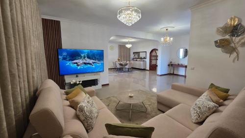 a living room with a couch and a flat screen tv at Santa Maria Villa in Funchal