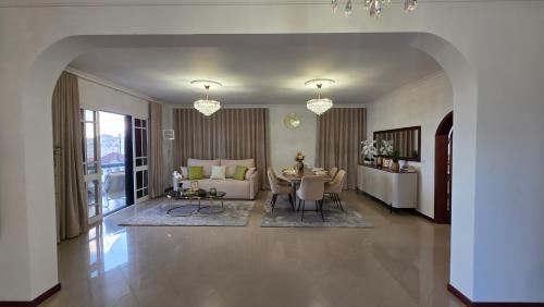a large living room with a table and a couch at Santa Maria Villa in Funchal