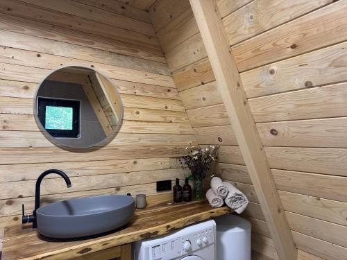 a bathroom with a sink and a mirror on a wall at Hygge villa in Žabljak
