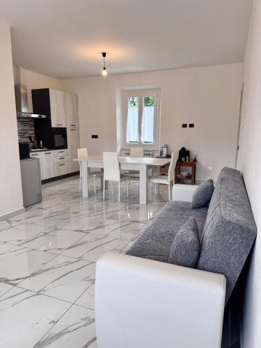 a living room with a couch and a table at appartamento Tortona in Tortona